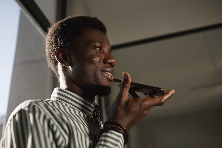 A person smiling while using their phone's smart assistant