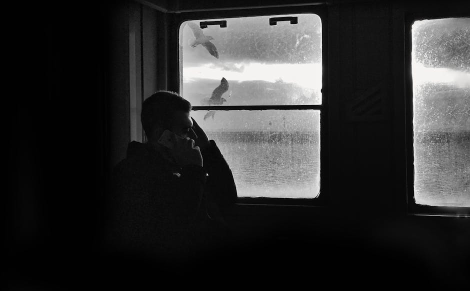 A person sitting in a sunlit window with a mug, looking calm and unhurried in the morning