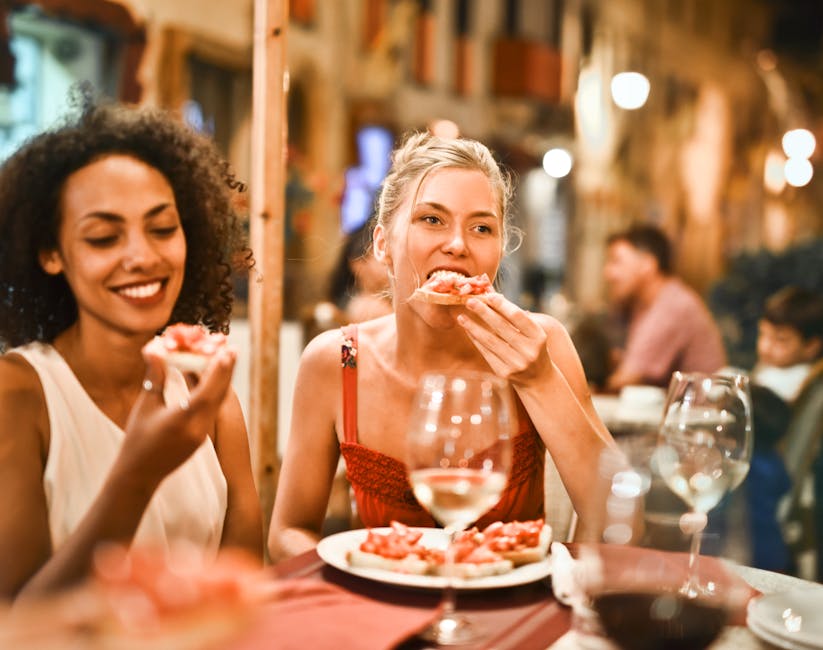 A person arriving at a restaurant right on time, greeted warmly by friends already seated