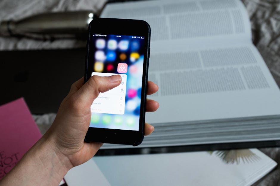 A smartphone resting next to an open journal on a table, representing the choice between digital and analog