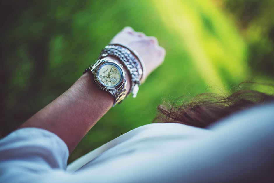 Close-up of a watch on a wrist against a soft natural background