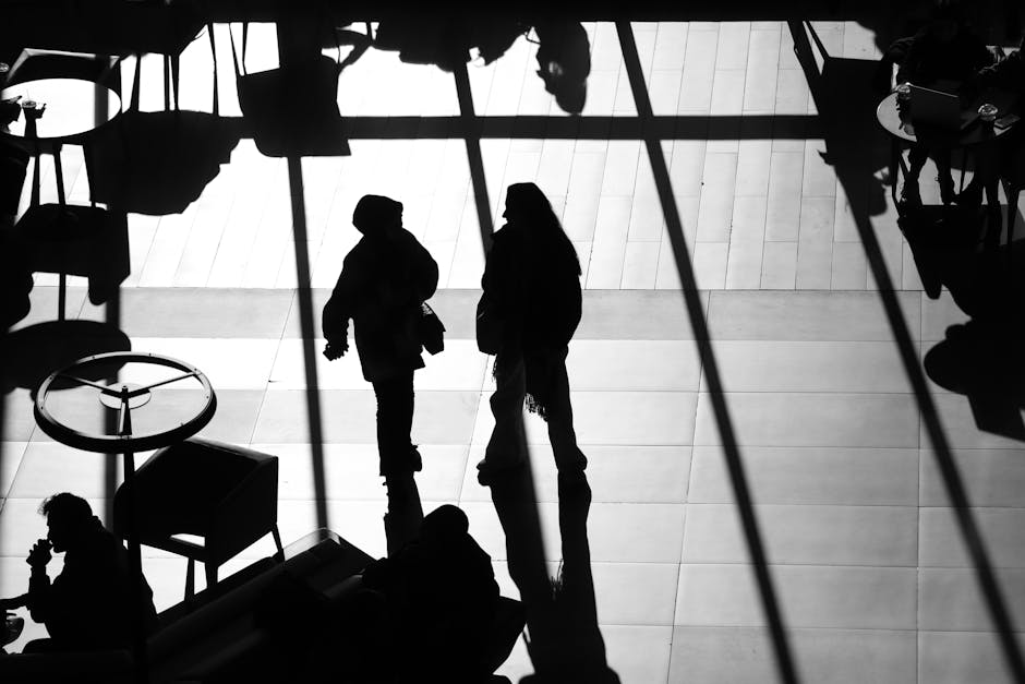Travelers eating at a bright, modern airport food hall with natural light coming through large windows