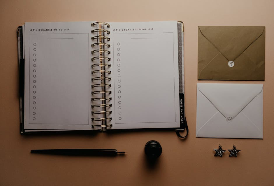 A minimal checklist written in a notebook on a white table with a pen resting beside it