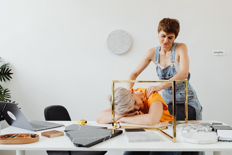 A person at a clean, simplified desk with just a laptop and a cup of coffee