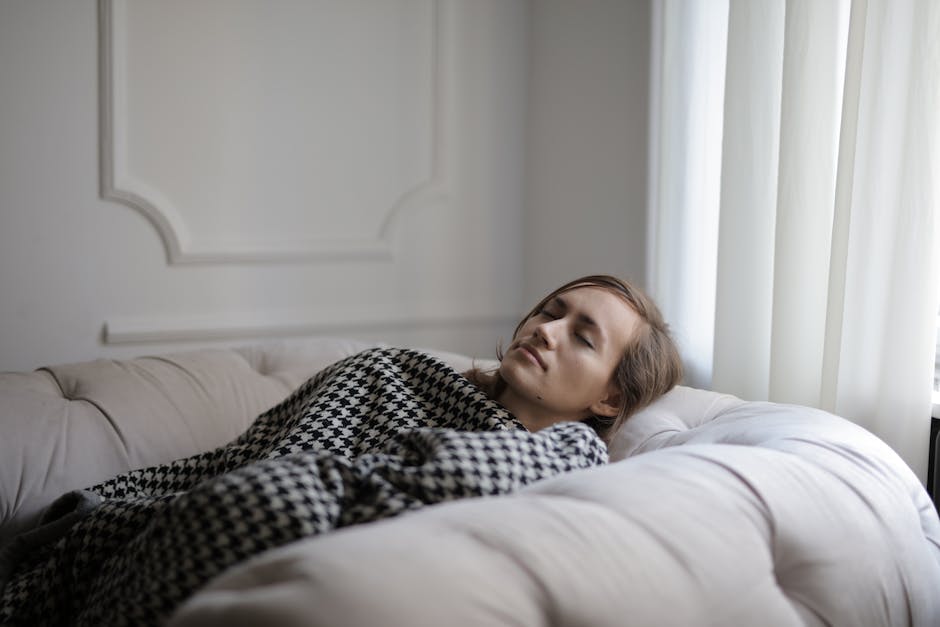 A tired person on the couch in warm afternoon light