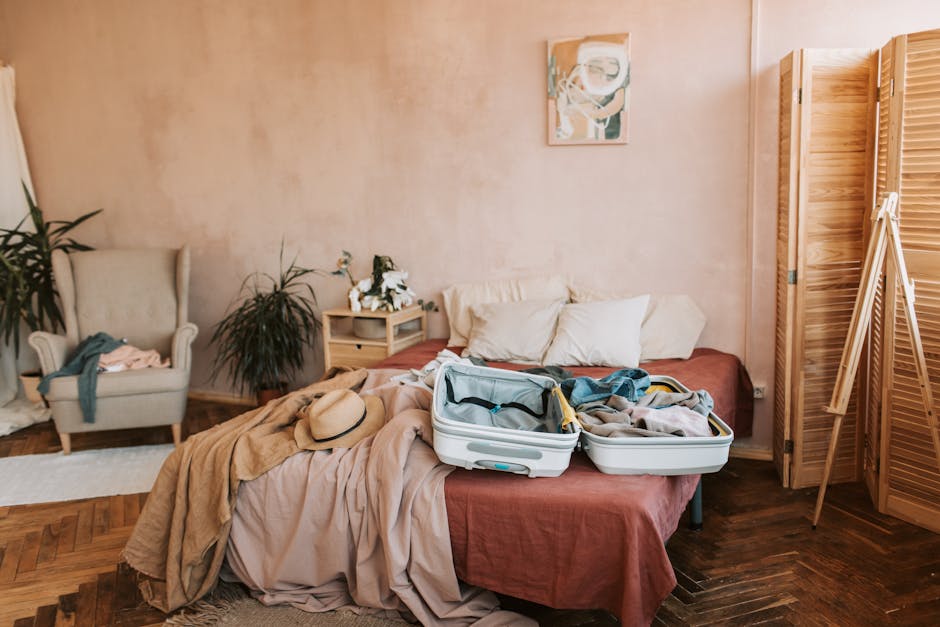 A person calmly packing a travel bag on a bed in a sunlit bedroom