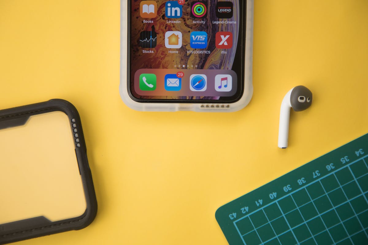 A smartphone on a desk surrounded by apps and planning tools