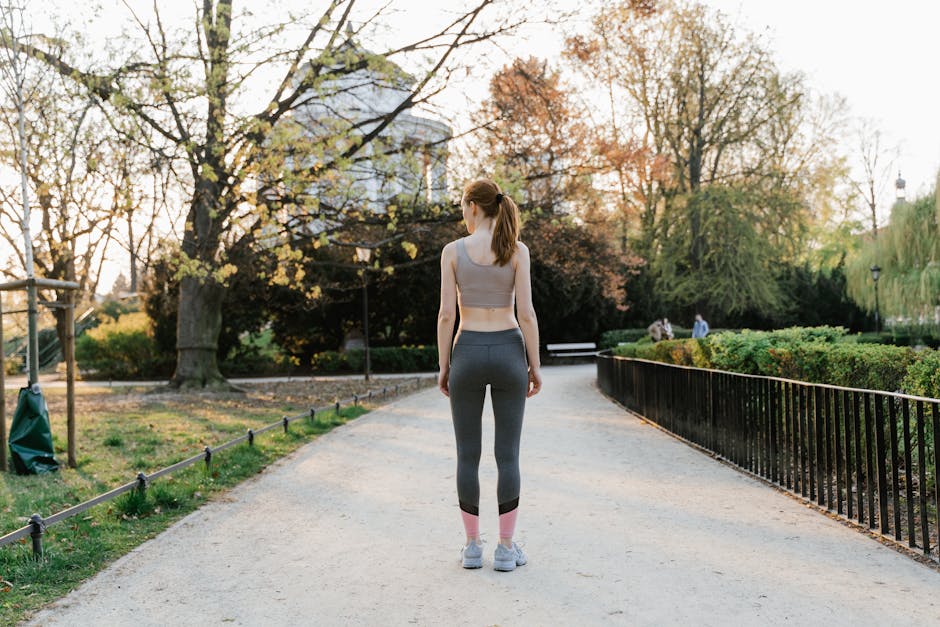 A person walking simply through a park in morning light