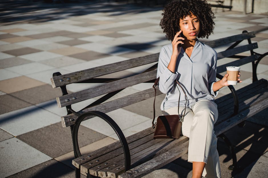 A person calmly reviewing their tasks on a phone over morning coffee
