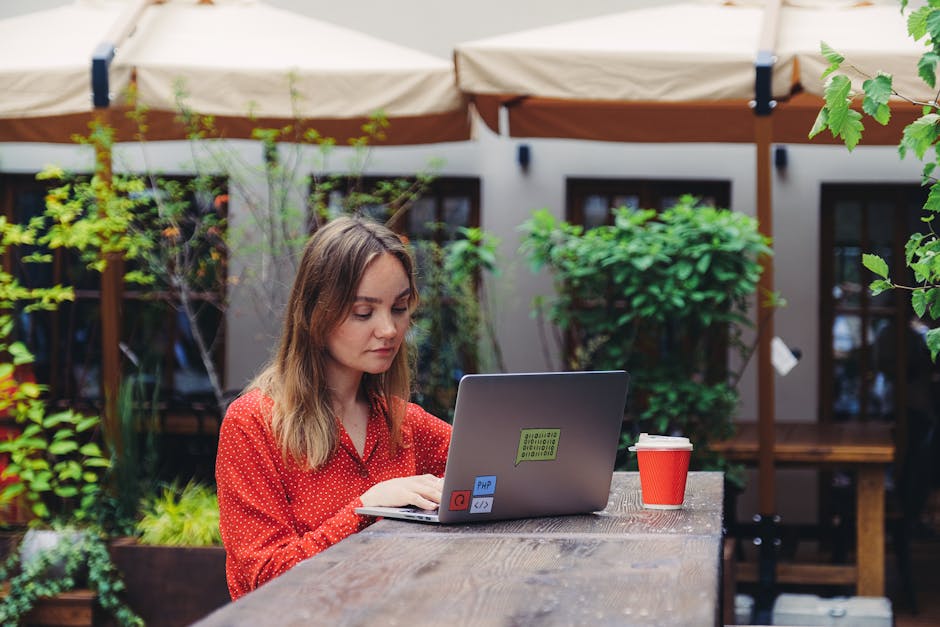 A freelancer working at a coffee shop with a laptop